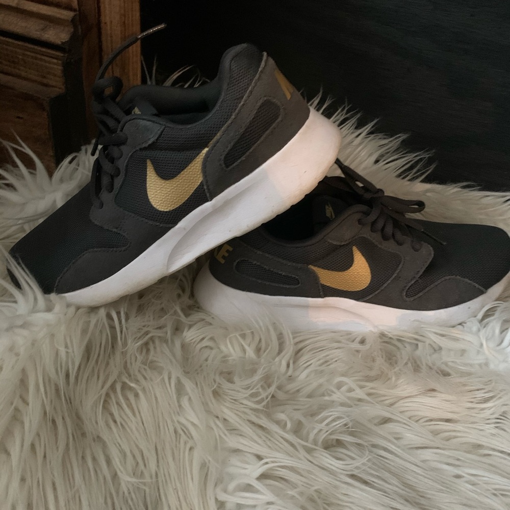 Gray and gold Nike sneakers